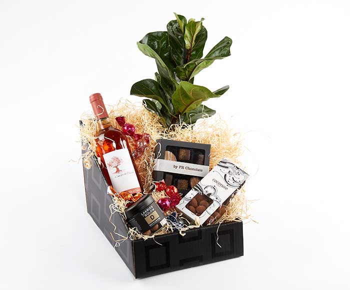 Send en jubilæumspakke med rosévin, chokolade og en plante.